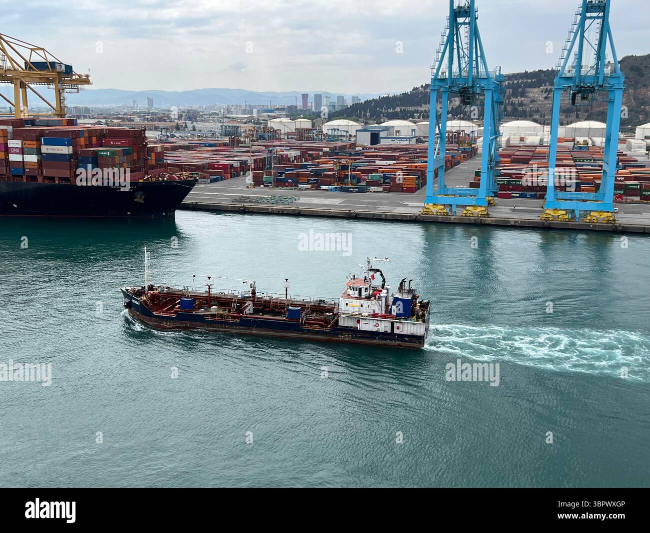 Barcellona, Spagna, 2 maggio 2022, Una nave da carico naviga attraverso un vivace porto, mostrando il commercio e i trasporti globali. Foto Stock