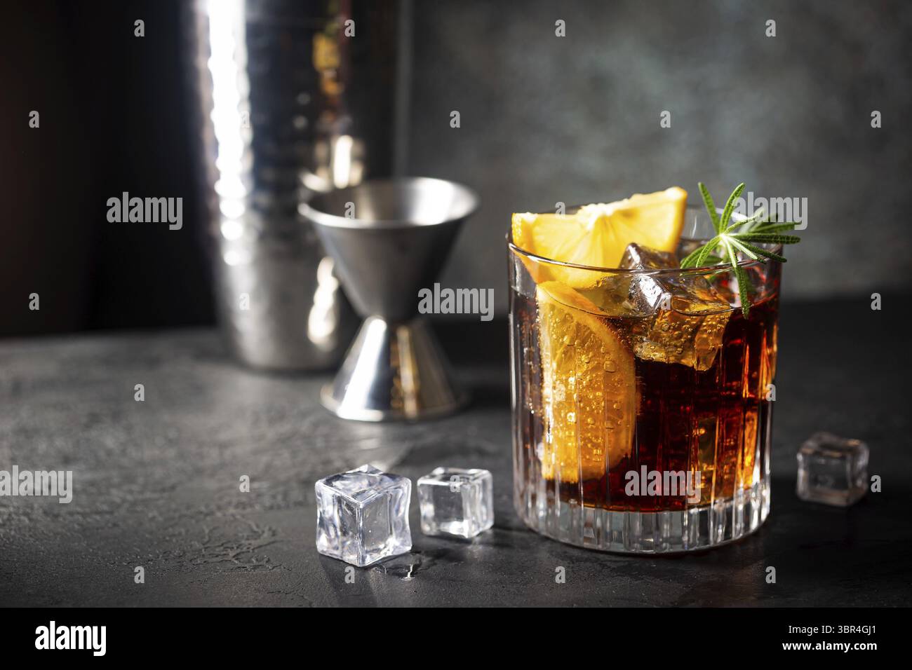 Cocktail Cuba Libre fresco con rum, cola e limone marrone su sfondo ligneo Foto Stock