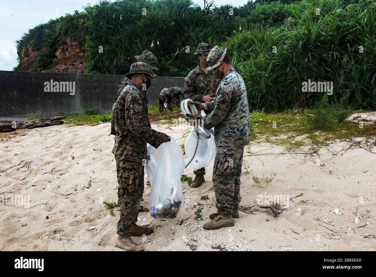 25 luglio 2020 - Kin Blue, Okinawa, Giappone - Marines con la squadra anti-armatura combinata 1 (CAAT), Battalion Landing Team, 2nd Battalion, 4th Marines, 31st Marine Expeditionary Unit (MEU), pulire la spiaggia di Kin Blue, Okinawa, Giappone, 25 luglio 2020. Al termine del loro addestramento, CAAT-1 ha raccolto la spazzatura che era stata lavata sulla spiaggia per lasciare l'ambiente migliore di quello che avevano trovato. Il 31° MEU, il Marine Corpsâ€™ solo MEU continuamente schierato in avanti, fornisce una forza flessibile e letale pronta a eseguire un'ampia gamma di operazioni militari come la principale forza di risposta alle crisi in th Foto Stock