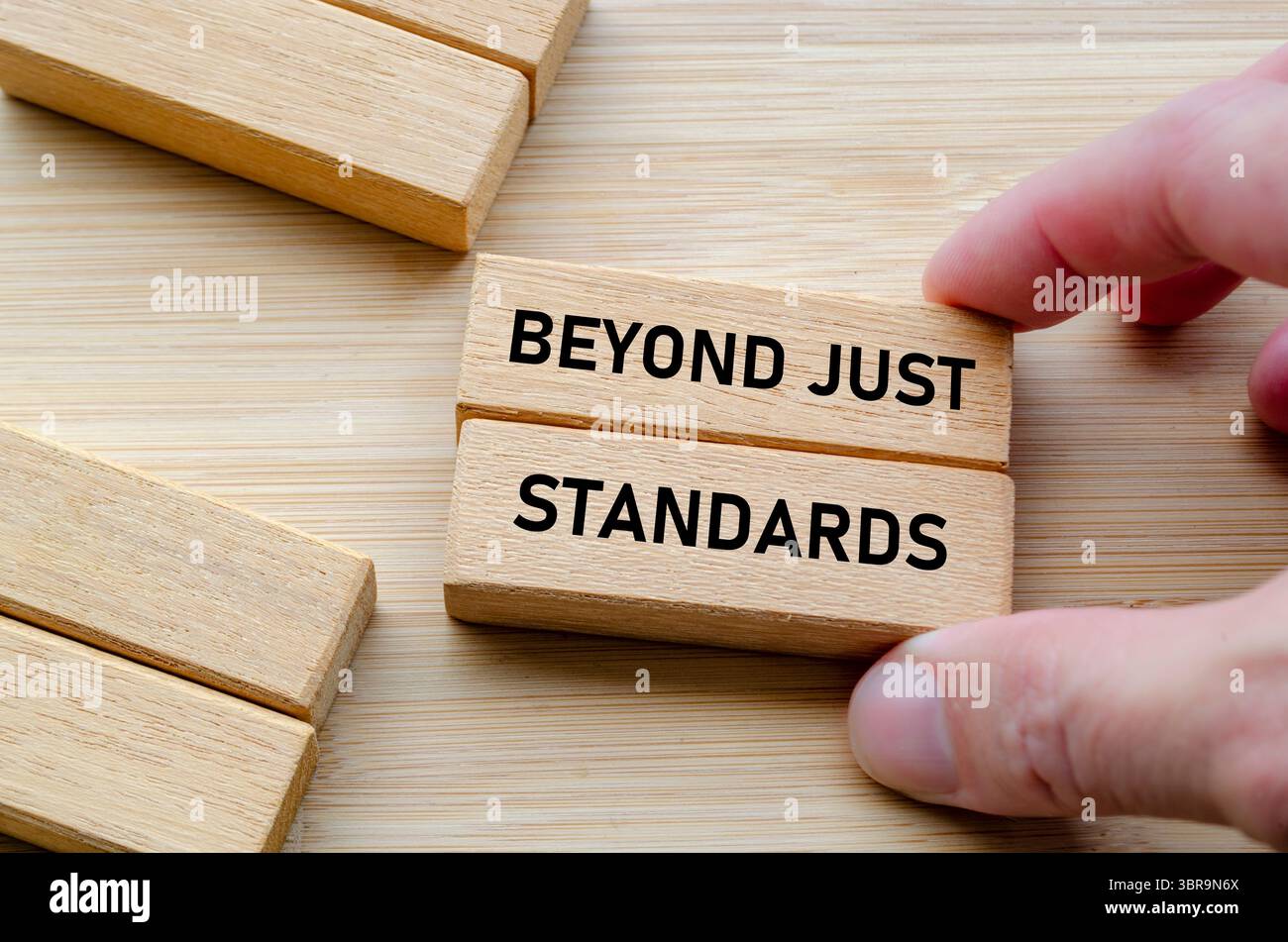 Oltre agli standard, il testo su blocchi di legno in mano evidenzia l'azione e la verità oltre le semplici dichiarazioni. Foto Stock