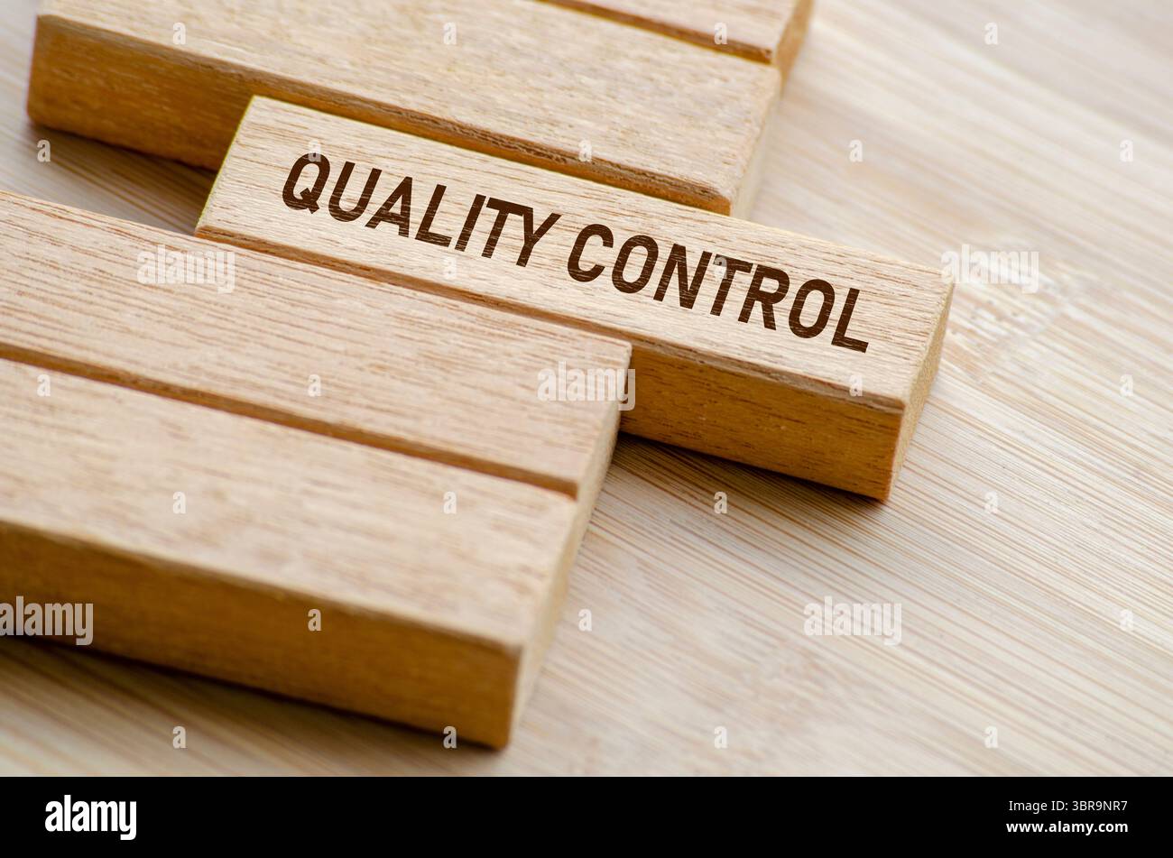 Testo controllo qualità su blocchi di legno. Concetto di business e controllo di qualità. Foto Stock