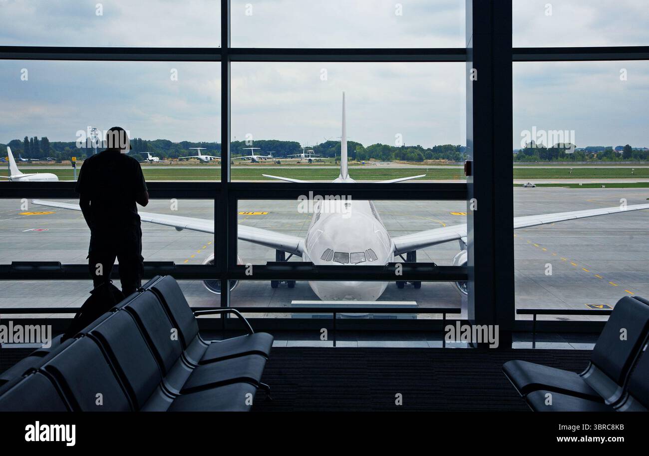 Uomo in aeroporto con una vista del piano Foto Stock