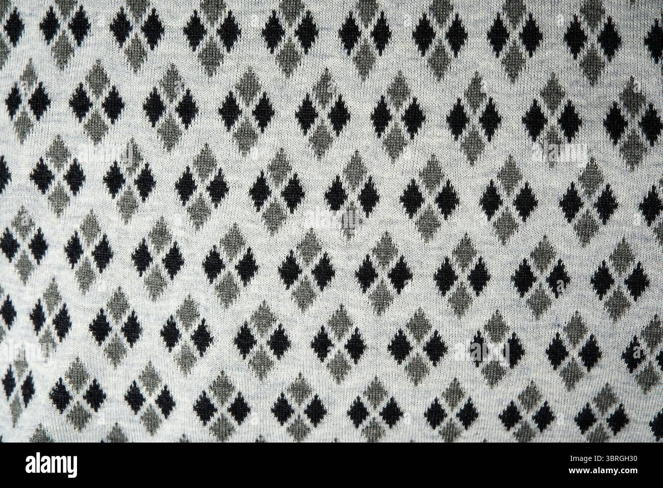 Bellissime forme di diamante bianco e nero adornano i tessuti morbidi, creando una texture. Foto Stock