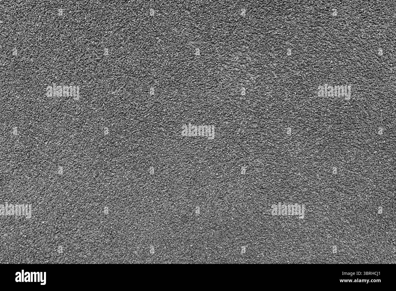 Granulosità di asfalto, intonaco, cemento, plastica, roccia, primo piano di pietra, macro. Sfondo della superficie granulare grigia della parete, sfondo ruvido Foto Stock