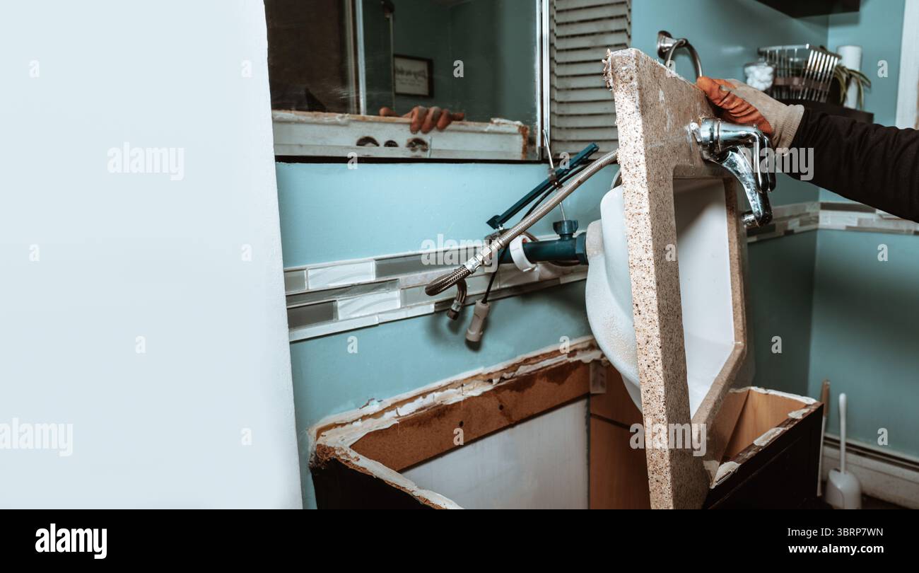 Sostituzione di un vecchio lavandino da bagno – concetto di impianto idraulico e ristrutturazione, progetto fai da te, sostituzione del rubinetto, manutenzione del bagno. Foto Stock
