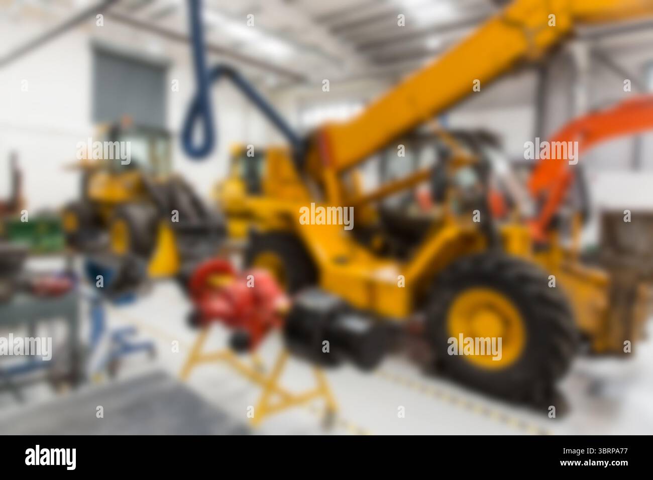 Immagine sfocata dei macchinari gialli Foto Stock