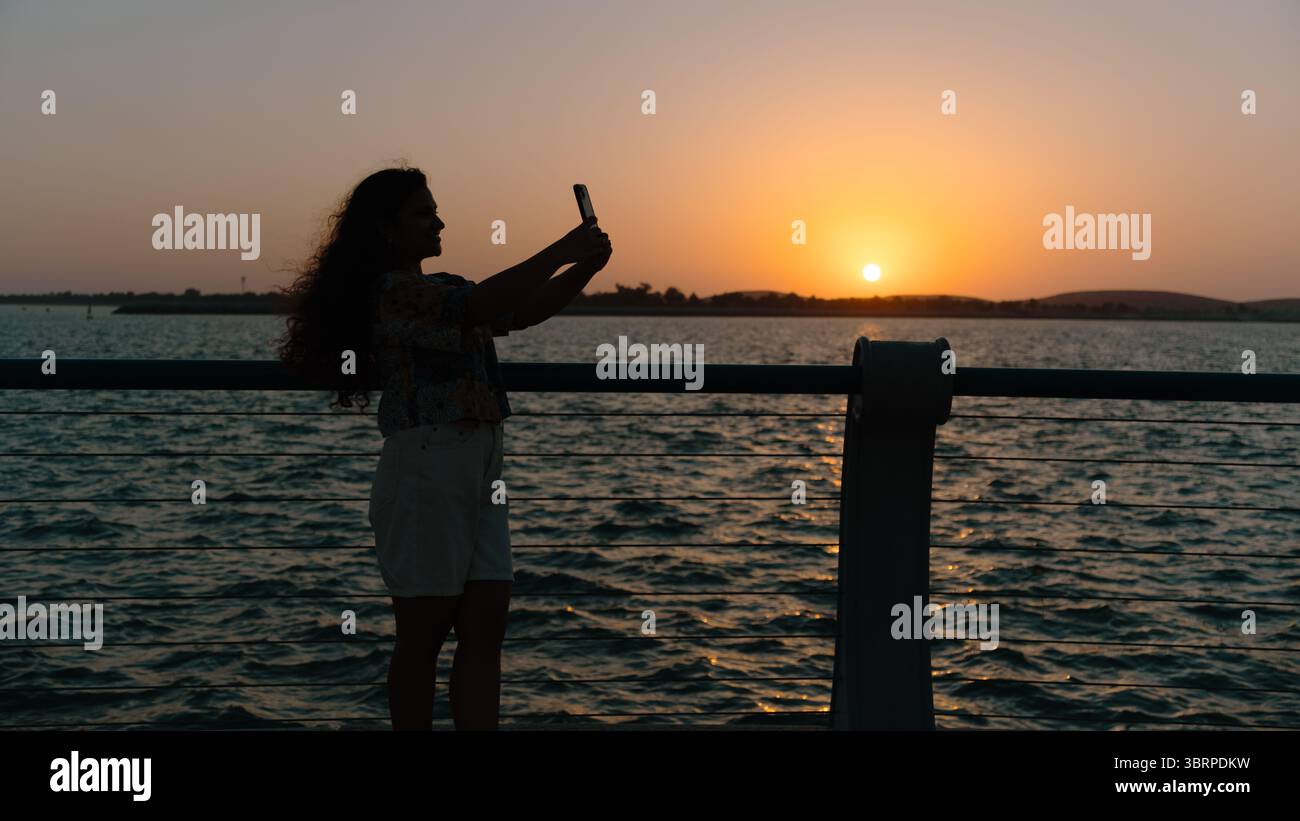silhouette di una donna sulla spiaggia Foto Stock