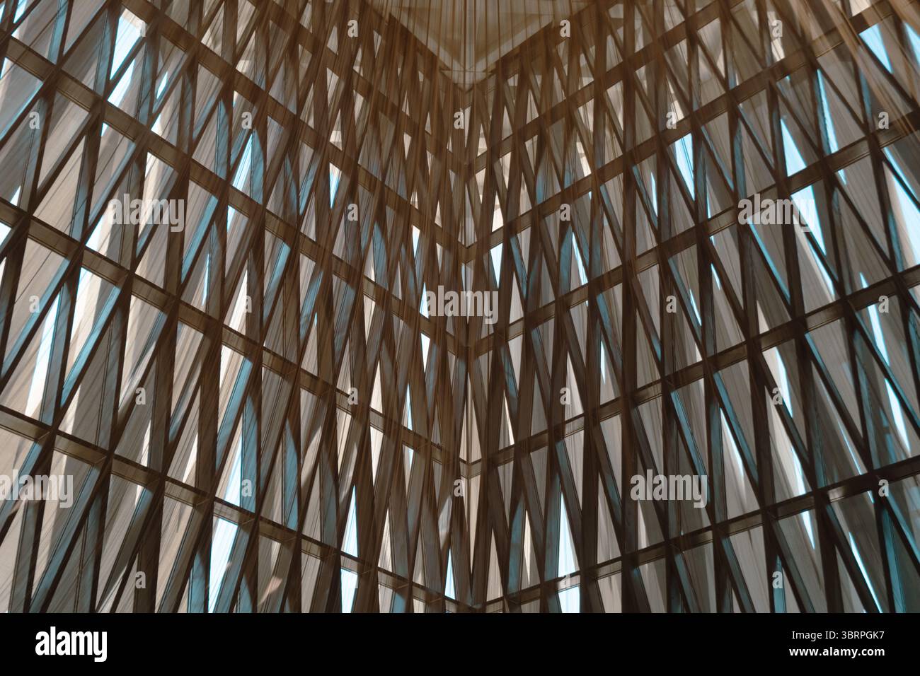 Schema geometrico di fasci intersecanti in uno spazio con soffitti alti e luce naturale che filtra attraverso gli spazi. Foto Stock