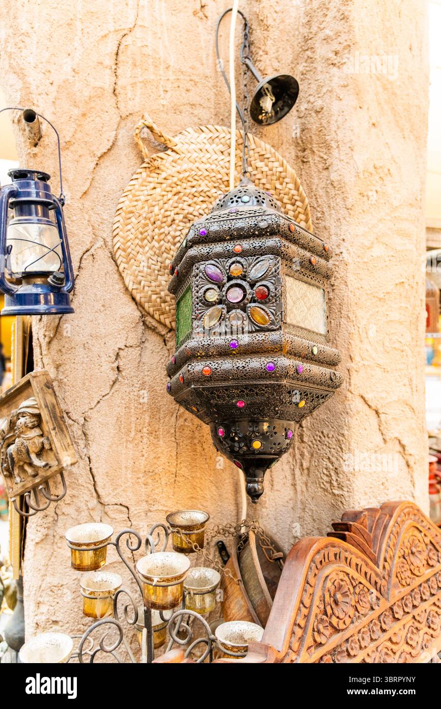 Lampada tradizionale araba d'epoca con vetrate colorate e decorazioni a specchio, lampada antica appesa sullo sfondo della vecchia parete Foto Stock