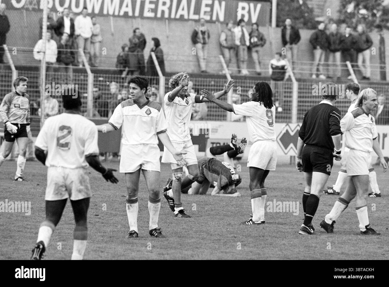 Football Haarlem - Telstar, Whizgle News, Dutch Desk, Paesi Bassi, 1950 - 2000 il 09-10-1993. Questi argomenti vengono visualizzati nell'immagine. La scena raffigura un vivace evento sportivo, probabilmente una partita di calcio, che si svolge su un campo erboso. I giocatori sono vestiti in uniforme bianca, suggerendo che fanno parte della stessa squadra. Le loro maglie sono impreziosite da numeri e lo stile unico di ogni giocatore contribuisce alla diversità visiva della scena. Alcuni atleti sembrano festeggiare un gioco di successo, con un giocatore che alza le braccia in trionfo mentre altri mostrano espressioni di eccitazione Foto Stock