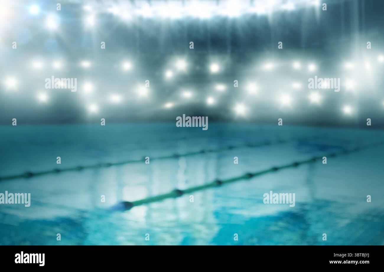 La piscina della concorrenza, dal design piatto, è illuminata sotto i riflettori luminosi con divisori di corsia diagonali Foto Stock