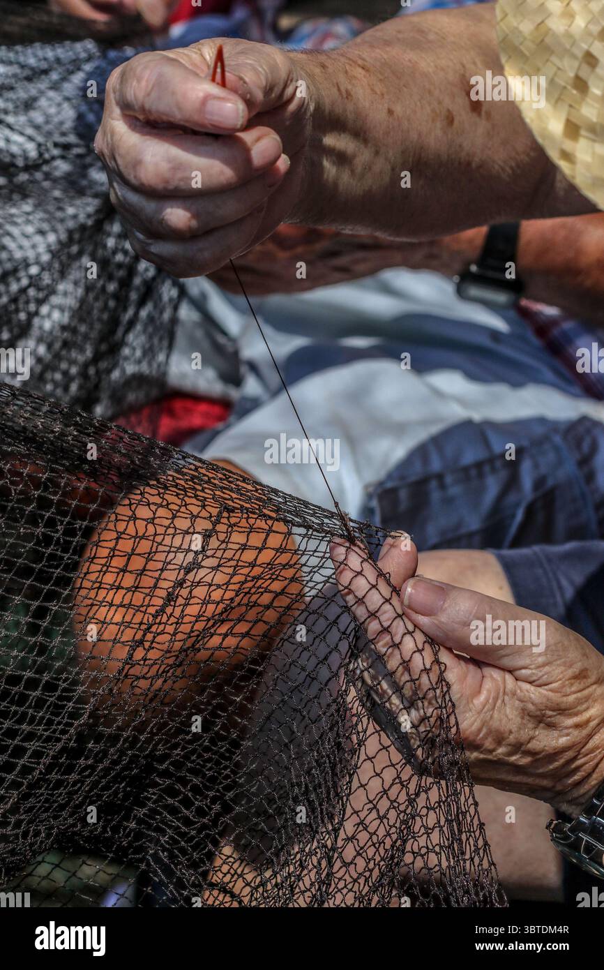 9 settembre 2020: 9 settembre 2020 (Caleta de Velez, Velez Malaga, Malaga) gruppo di pescatori riparano le reti nel porto di Caleta de Velez con l'arte di mending. Questo danno alle reti del fishermenâ è causato dal delfino in attesa che le barche riempiano le loro reti di pesce, ed è in quel momento che si avvicina a mangiare la merce già catturata. (Immagine di credito: © Lorenzo Carnero/ZUMA Wire) Foto Stock