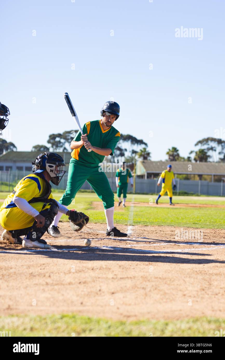 Giocatori di baseball maschi che competono in una partita di baseball sul campo con mazza e guanto di catcher, copia spazio Foto Stock