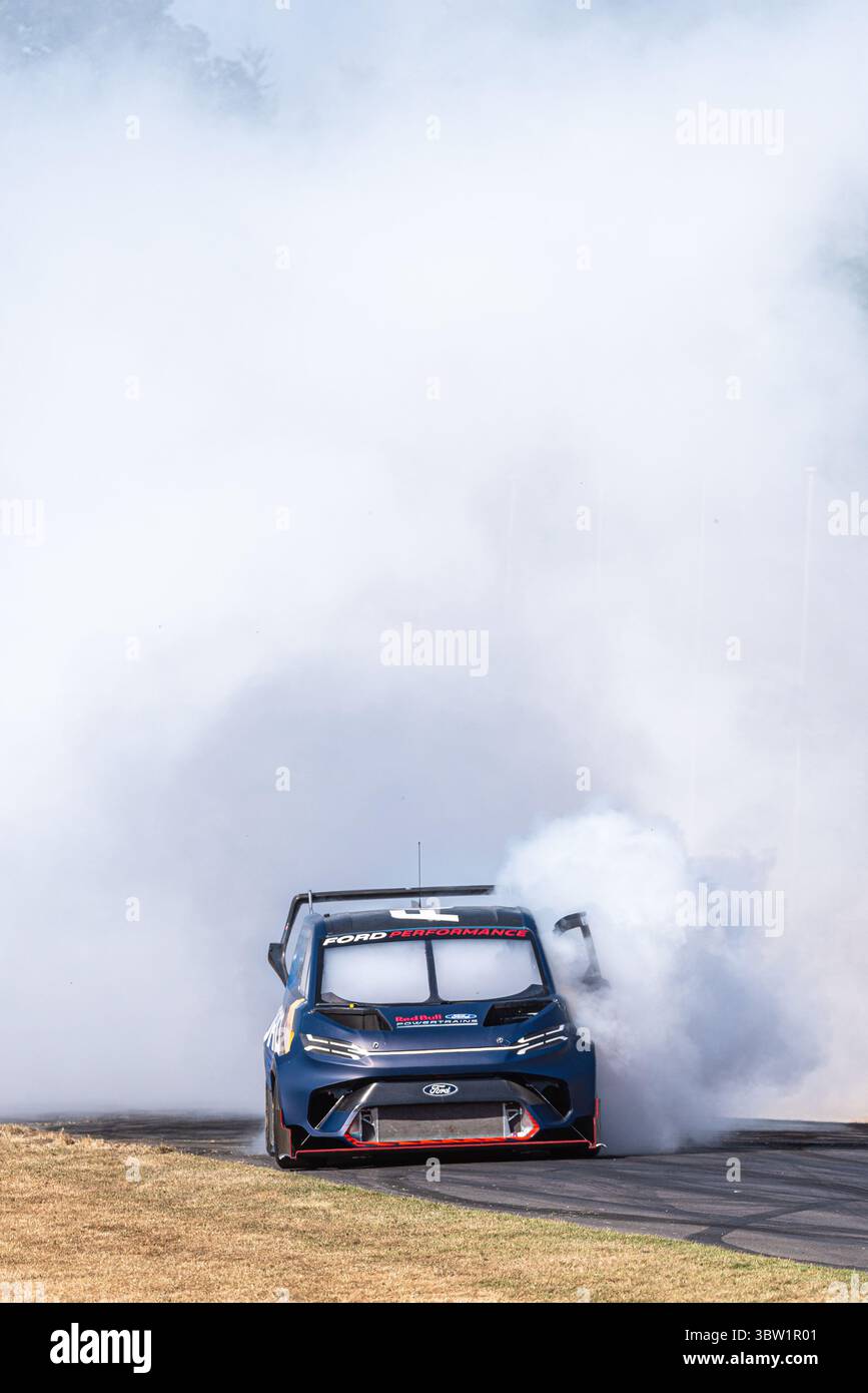 2023 Ford e Transit Supervan 4,2 furgone elettrico personalizzato che guida su pista per arrampicata Goodwood Festival of Speed 2025 Motorsport event. Bruciare il fumo degli pneumatici Foto Stock