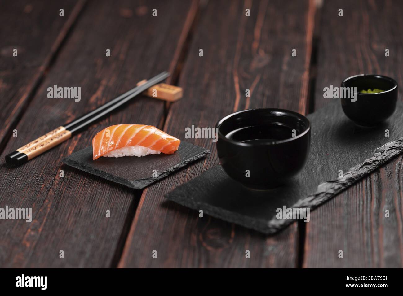 Sushi giapponese. Vista dall'alto del sushi nigiri assortito con salmone su fondo naturale in pietra, formato verticale Foto Stock