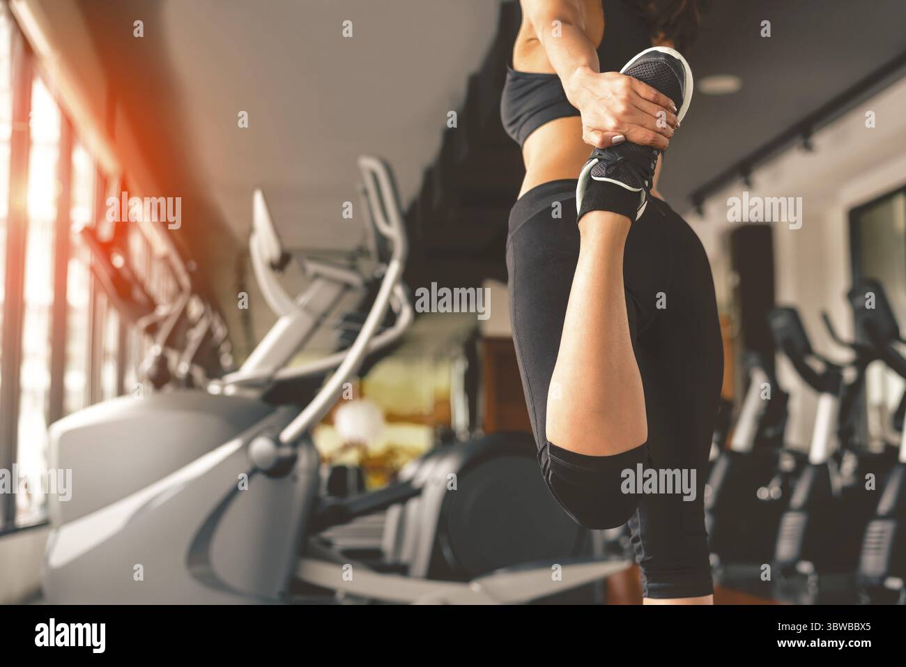 Vista posteriore della donna fare yoga in fitness sport training club con attrezzature sportive e accessori. Allenamento culturista e concetto. Stili di vita tempo libero Foto Stock