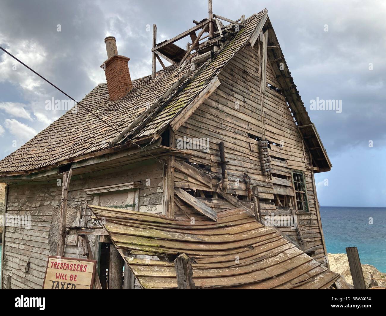 Iconico set cinematografico del villaggio di braccio di ferro e scene di parco divertimenti, con vivaci case in legno, oggetti di scena e la costa di Anchor Bay sotto il giglio del Mediterraneo Foto Stock