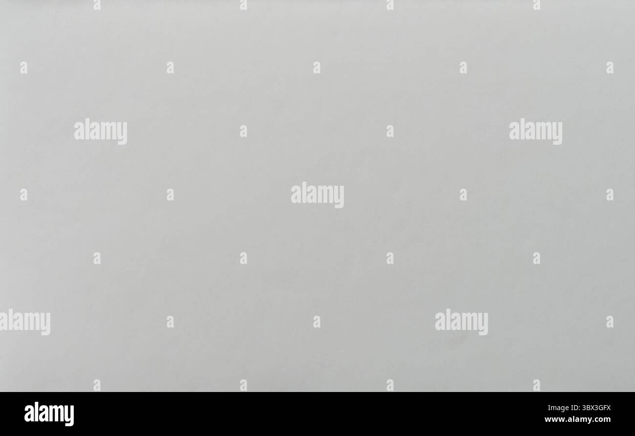 La superficie semplice in grigio chiaro mostra una consistenza liscia con sottili variazioni e un aspetto tranquillo, invitante semplicità. Foto Stock