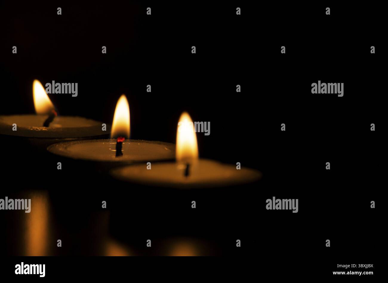 Le candele brillano al buio con spazio personalizzabile per messaggi, testo o idee Foto Stock