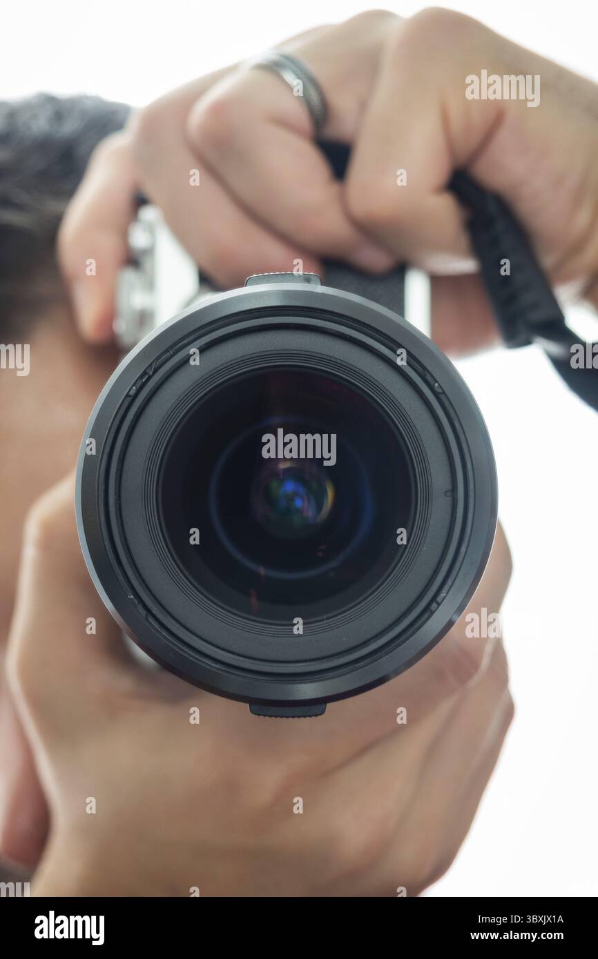 Uomo che scatta una foto tenendo la fotocamera in posizione verticale Foto Stock