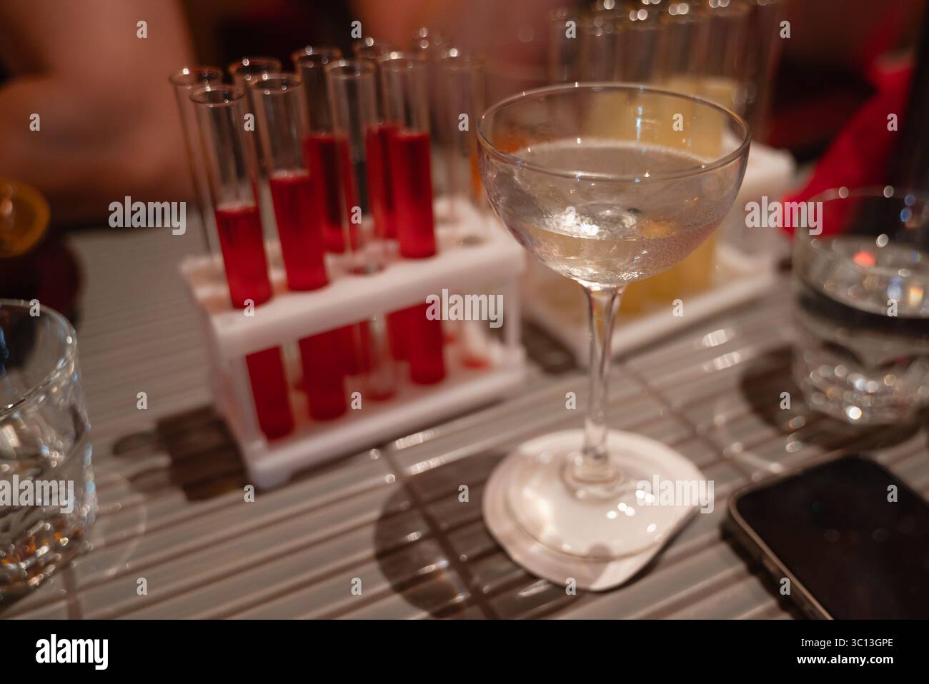 Una presentazione fantasiosa di cocktail utilizza diversi bicchieri e provette per un'esperienza unica Foto Stock