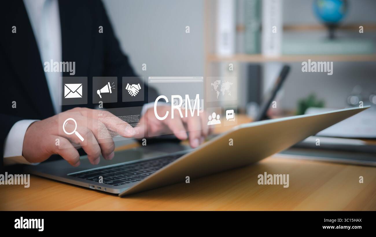 Software CRM utilizzato da un uomo d'affari su un notebook per la gestione digitale delle relazioni con i clienti, l'analisi del marketing e la tecnologia di comunicazione per ufficio. Foto Stock