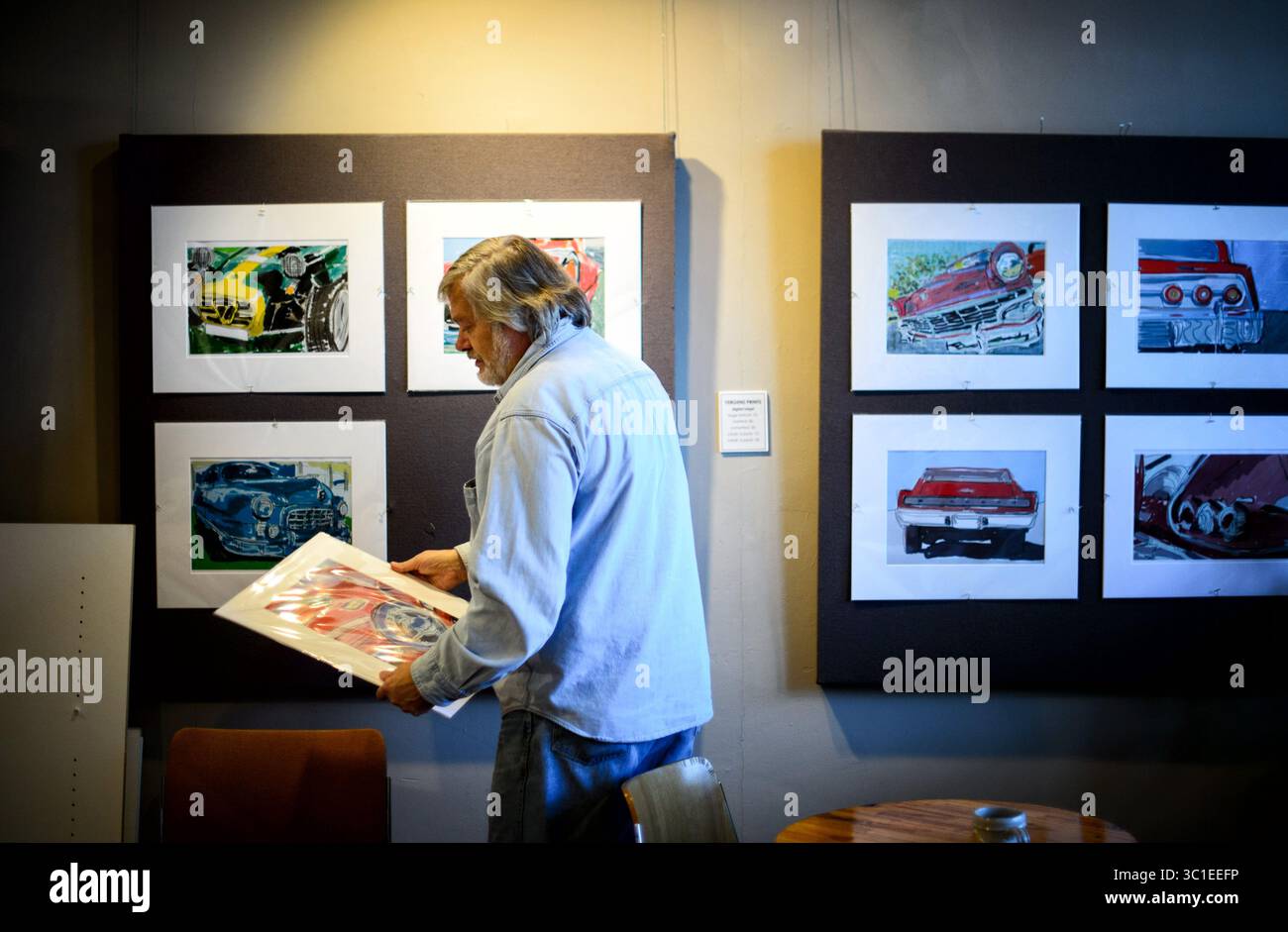 11 dicembre 2015 - St. Paul, Minnesota, Stati Uniti - Dave Thune ha ritirato pezzi da una precedente mostra d'arte per fare posto a una nuova nella sua galleria d'arte di St. Paul. Venerdì 10 dicembre 2015, in una città di politici colorati e poco ortodossi, Dave Thune si è distinto per anni a St. Paul. Per 20 anni è stato uno dei membri più efficaci del Consiglio comunale della città, guidando l'accusa su questioni impopolari come i diritti dei gay e i divieti di fumo. È difficile mancare alle riunioni del consiglio; in una sala di abiti da lavoro, Thune sarà l'unico a indossare una camicia hawaiana o una flanella a quadri. I suoi piani per la pensione sono tipici Foto Stock