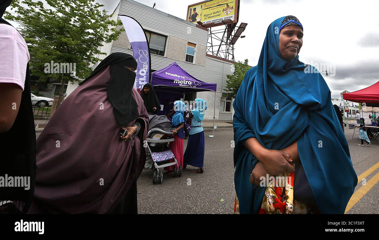 13 giugno 2015 - Minneapolis, Minnesota, Stati Uniti - le donne in abito musulmano hanno aspettato un'attrazione al festival dove i bambini potevano giocare. / Minneapolis, MN / 13 giugno 2015 / 14:00 PM – INFORMAZIONI GENERALI: Festival Somalo Independence Day il 13 giugno 2015 a Minneapolis. Questo evento comprenderà tre isolati da Lake St, una delle strade più trafficate di Minneapolis, tra Blaisdell Ave e Grant Ave. In modo appropriato vicino al più grande centro commerciale Somali del Minnesota. Questo festival si terrà dalle 13:00 alle 20:00. Durante tutto il giorno, il pubblico sperimenterà musica dal vivo con artisti locali. Art Gall Foto Stock