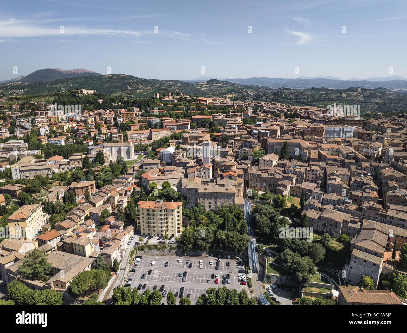Vista aerea della calda luce del sole che illumina antichi edifici e strutture moderne, gettando lunghe ombre nel paesaggio, Perugia, Umbria, Italia. Foto Stock