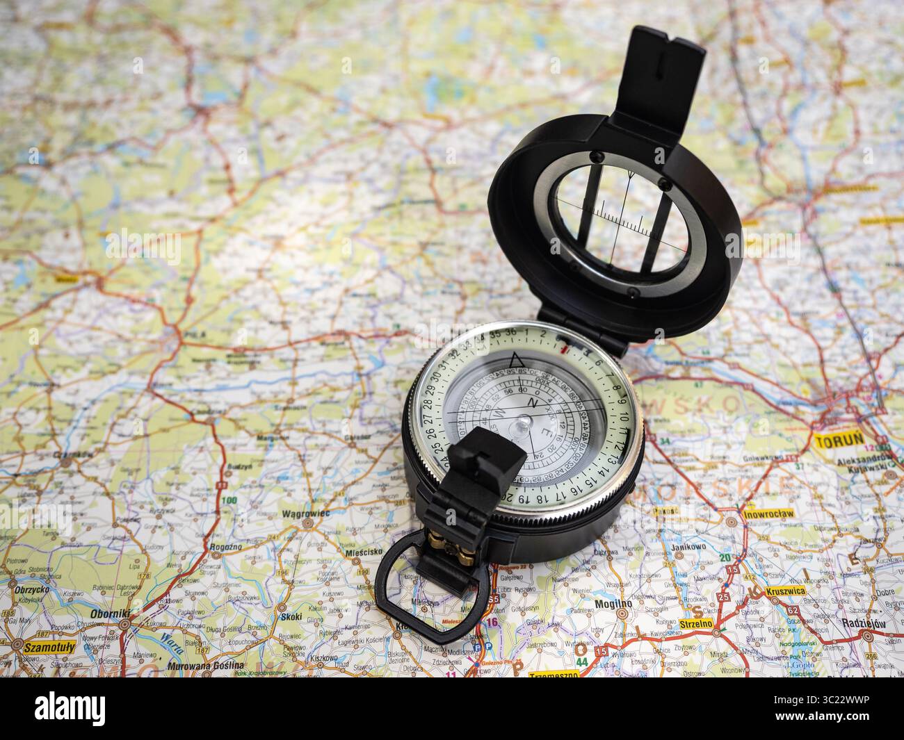 Una classica bussola portatile visualizzata su una mappa dettagliata che simboleggia la navigazione, l'esplorazione e le avventure di viaggio. Perfetto per viaggiatori e avventurieri Foto Stock