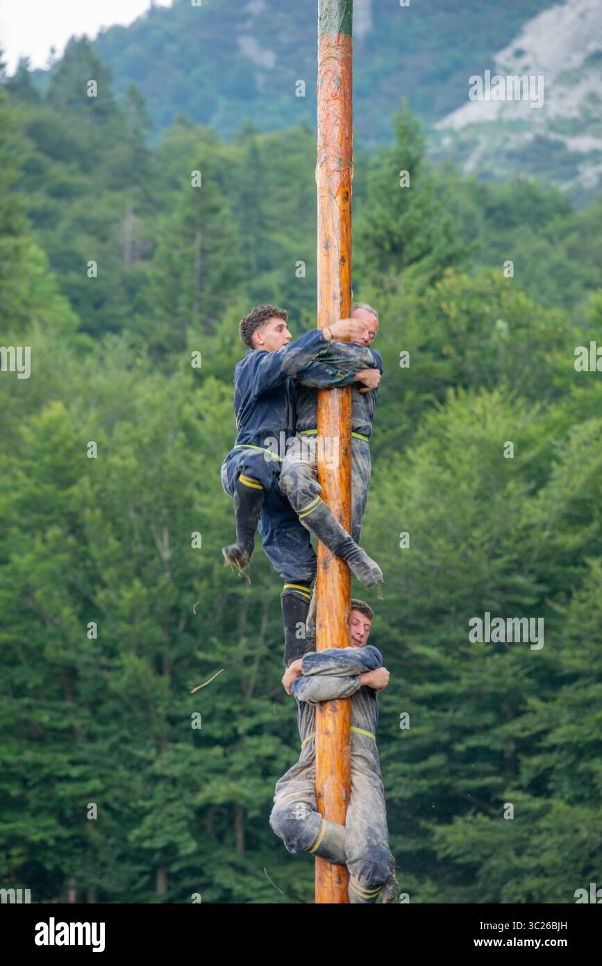 Bergamo Italia 20 luglio 2025: I partecipanti al festival popolare si sfidano a vicenda cercando di raggiungere la cima del palo Foto Stock