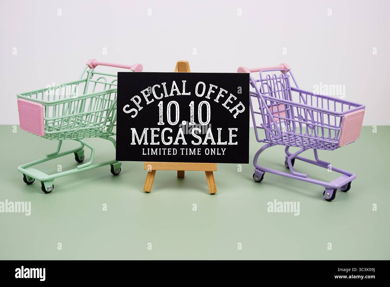 Testo dell'offerta speciale Mega sale 10,10 con carrello mini trolley su sfondo verde Foto Stock