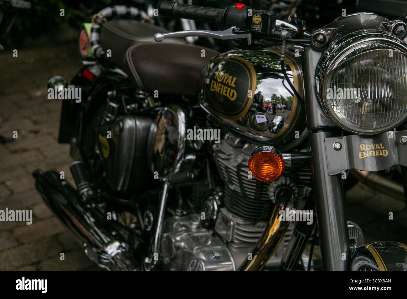 Vista ravvicinata di una classica motocicletta Royal Enfield parcheggiata su una strada acciottolata che mostra dettagli cromati e design vintage al Calne bike Meet Foto Stock