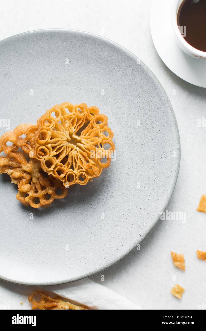 Vista dall'alto dello snack sassafa nigeriano settentrionale, vista dall'alto dei biscotti alle rosette su un piatto grigio Foto Stock