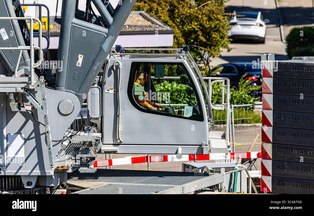 Kloten, Svizzera, 12 luglio 2025: L'operatore della gru cingolata Lieberherr LR 1750/2 da 750 tonnellate si sta concentrando sul suo lavoro durante la demo Foto Stock