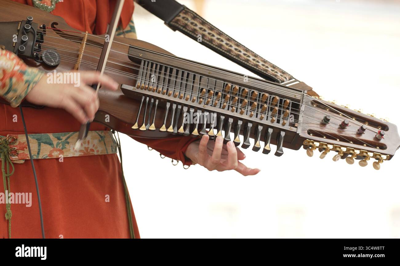 Donna che suona nyckelharpa al festival di musica folk. Foto Stock