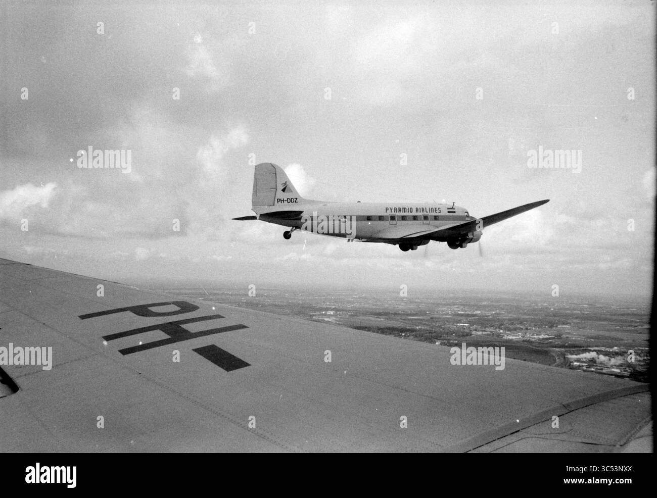 Pick up Dakota in America, aviazione, foto aeree, aerei, 00-07-1987 Whizgle News, Dutch Desk, Paesi Bassi, 1950-2000 Un aereo d'epoca vola in prossimità di un altro aereo, mostrando l'ala di un aereo con il suo numero di immatricolazione visibile. La scena cattura un cielo ampio disseminato di nuvole, mettendo in evidenza la bellezza dei viaggi aerei di un'epoca passata. Foto Stock Pick up Dakota in America, aviazione, foto aeree, aerei, 00-07-1987 Whizgle News, Dutch Desk, Paesi Bassi, 1950-2000 Un aereo d'epoca vola in prossimità di un altro aereo, mostrando l'ala di un aereo con il suo numero di immatricolazione visibile. La scena cattura un cielo ampio disseminato di nuvole, mettendo in evidenza la bellezza dei viaggi aerei di un'epoca passata. Foto Stock