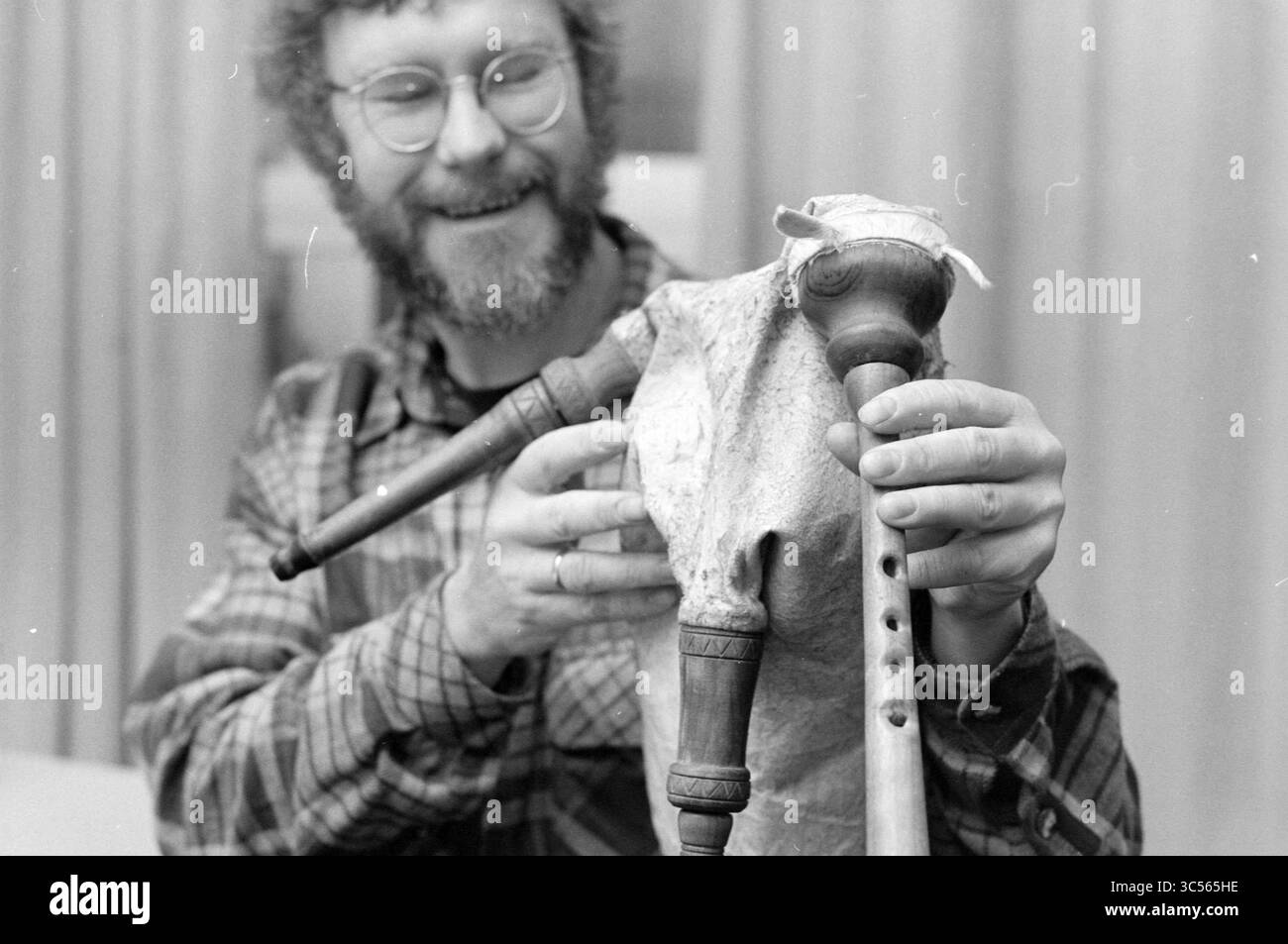 Rob Hinze con cornamuse, Haarlem, Paesi Bassi, 12-01-1994 Whizgle News, Dutch Desk, i Paesi Bassi, 1950-2000 Anni Un individuo sorridente regge uno strumento musicale unico e artigianale che assomiglia a una figura, con caratteristiche ed elementi decorativi distinti. La persona sembra impegnata e felice, mostrando la maestria artigianale dell'oggetto. Foto Stock