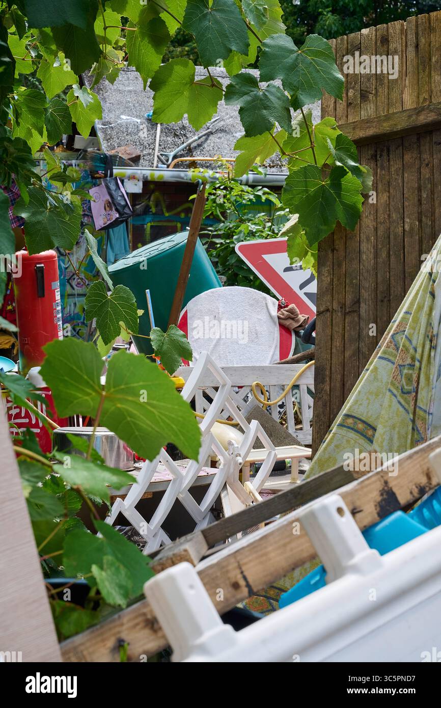 Materielle Adipositas, Garten mit Gegenständen eines sammelwütigen Menschen Foto Stock