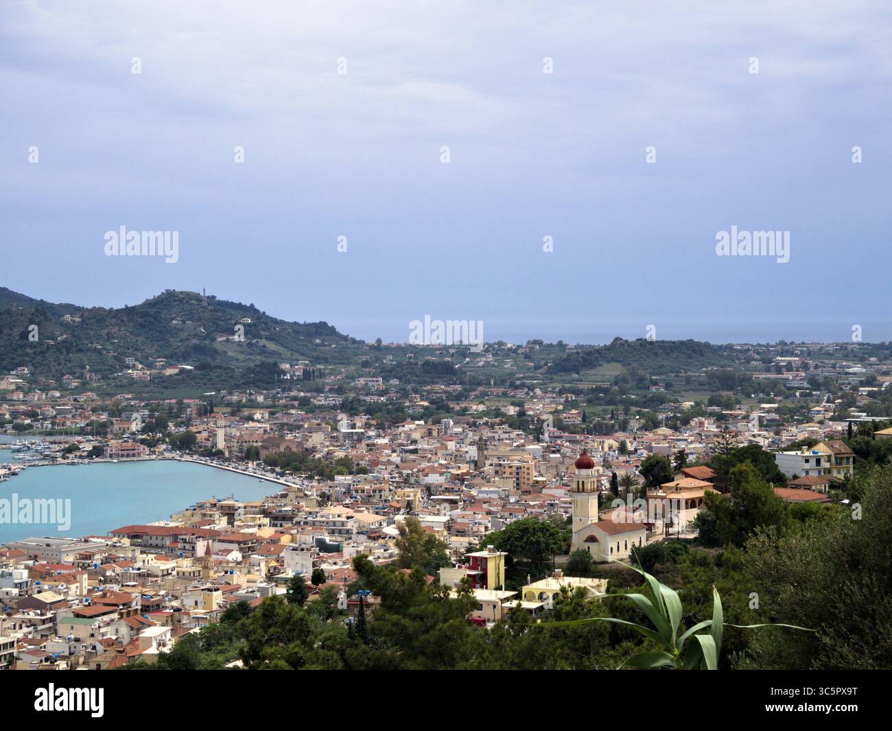 Vista aerea della capitale di Zante con edifici color pastello, costa e cielo mediterraneo coperto. Foto Stock