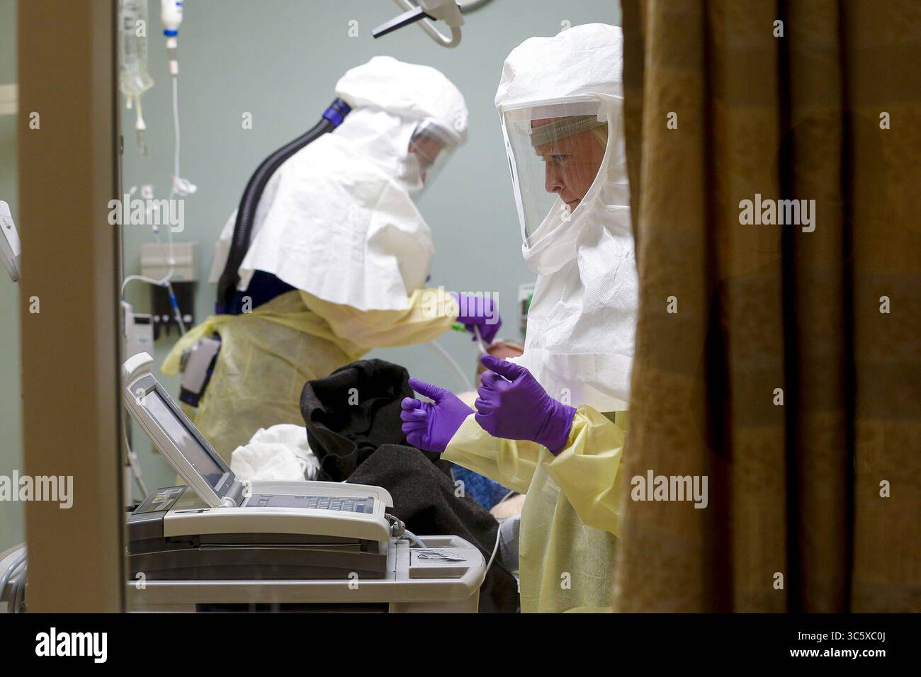 26 marzo 2020, San Diego, California, Stati Uniti: Al Sharp Memorial Hospital di San Diego, gli infermieri trattano un paziente diagnosticato con coronavirus in una speciale stanza di isolamento. (Immagine di credito: © Nelvin C. Cepeda/TNS tramite filo ZUMA) Foto Stock