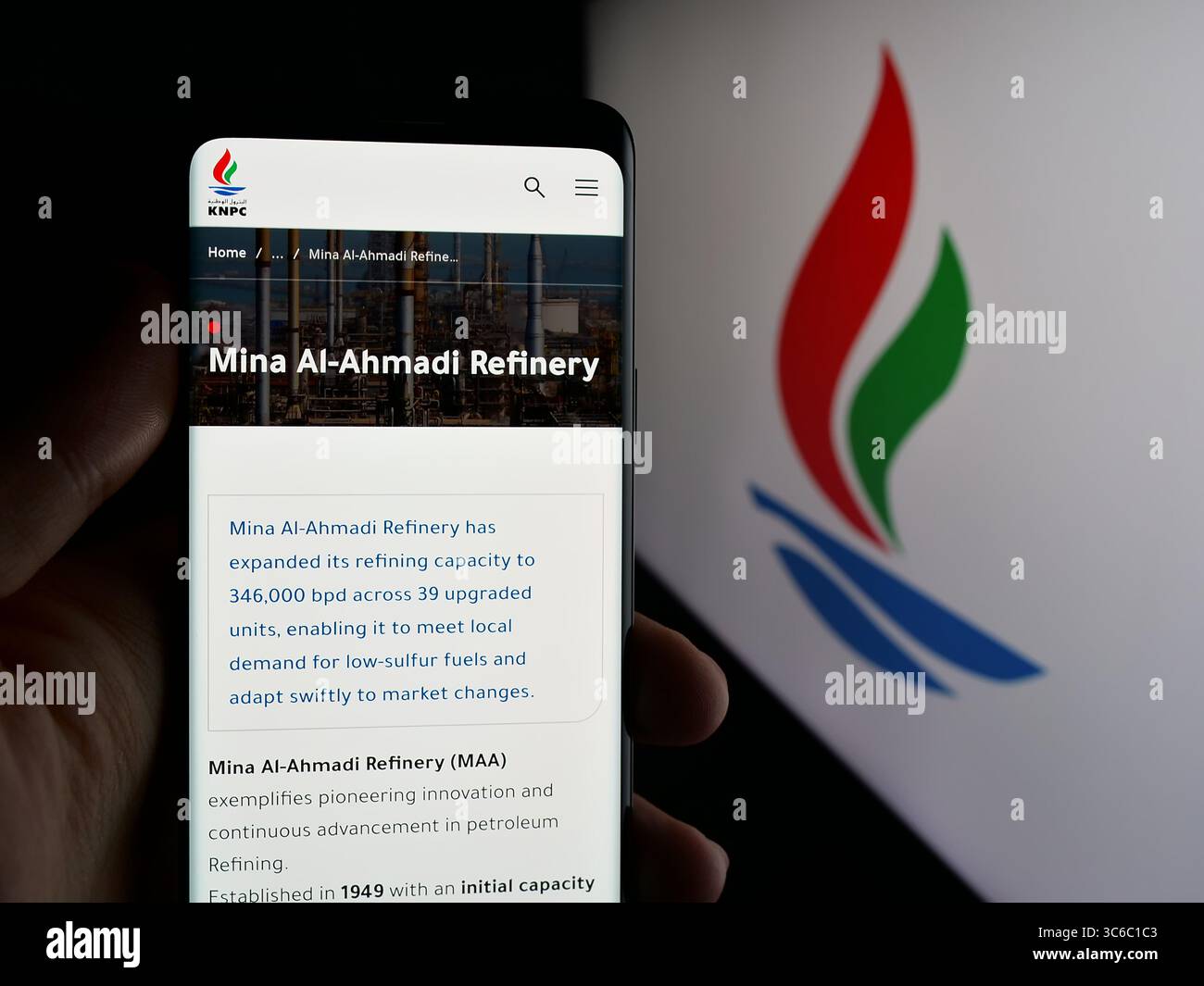 Stoccarda, Germania - 06-18-2025: Persona che detiene il cellulare con pagina web della Kuwait National Petroleum Company (KNPC) sullo schermo davanti al logo. Foto Stock