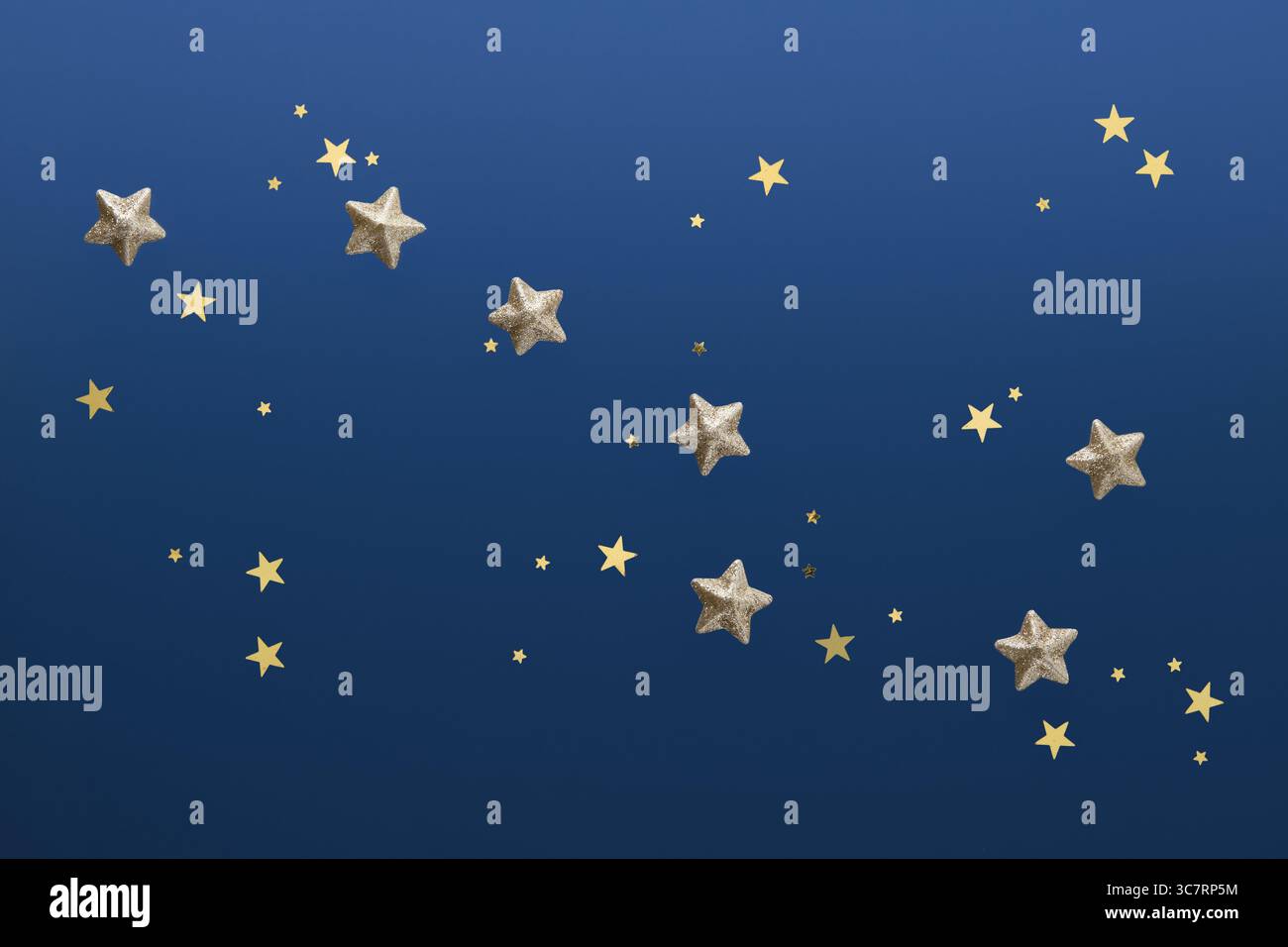 La costellazione dell'Orsa maggiore, fiancheggiata da brillanti stelle d'oro e coriandoli su sfondo blu Foto Stock