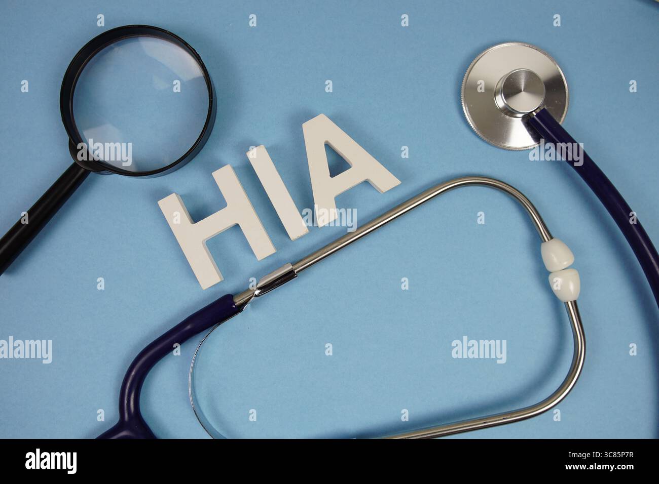 HIA abbreviazione di Health Impact Assessment lettere alfabetiche con lente di ingrandimento e stetoscopio su sfondo blu Foto Stock