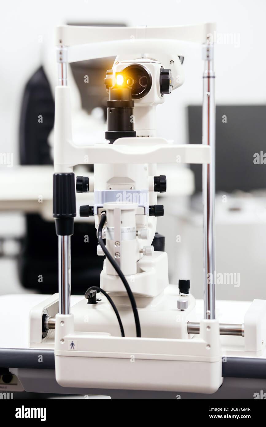 Il dispositivo per esame oftalmico è dotato di una lente illuminata che dimostra tecnologia avanzata e ingegneria di precisione in un ambiente clinico incentrato Foto Stock