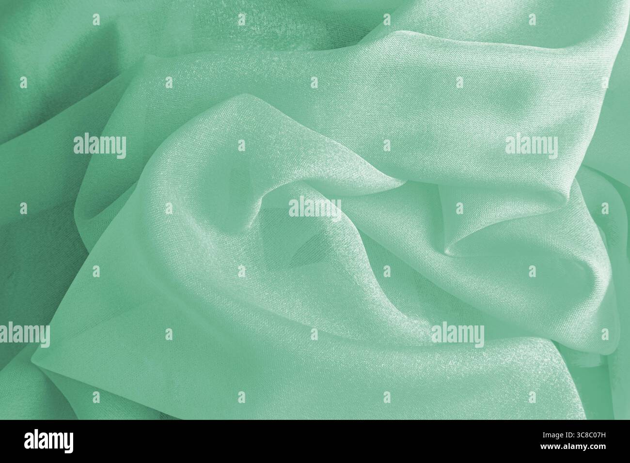 Lo spazio sullo sfondo è di seta delicata color menta. bellissime ed eleganti onde di tessuto di seta. layout per la progettazione. Una copia dello spazio Foto Stock