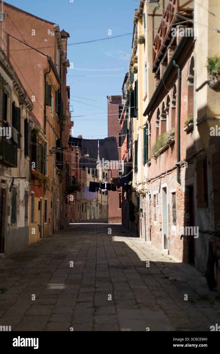 Lavanderia sospesa sopra un tranquillo vicolo veneziano Foto Stock