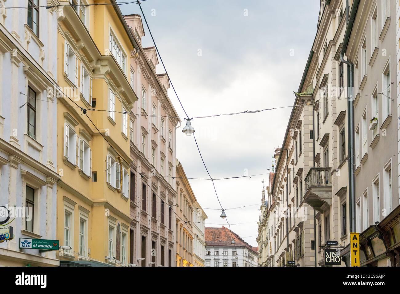 Vista di edifici colorati che proiettano ombre tenui, intricati dettagli architettonici sotto un cielo coperto lungo una strada stretta, Graz, Stiria, Austria. Foto Stock