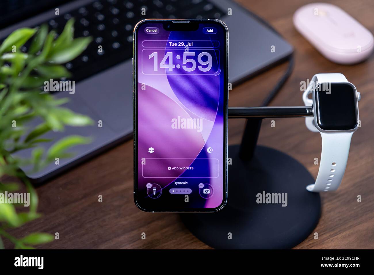 Poznan, Polonia - 29 luglio 2025: Apple iPhone con ios 26 Liquid Glass, con Apple Watch sullo stand, che raffigura la moderna tecnologia intelligente connessa Foto Stock