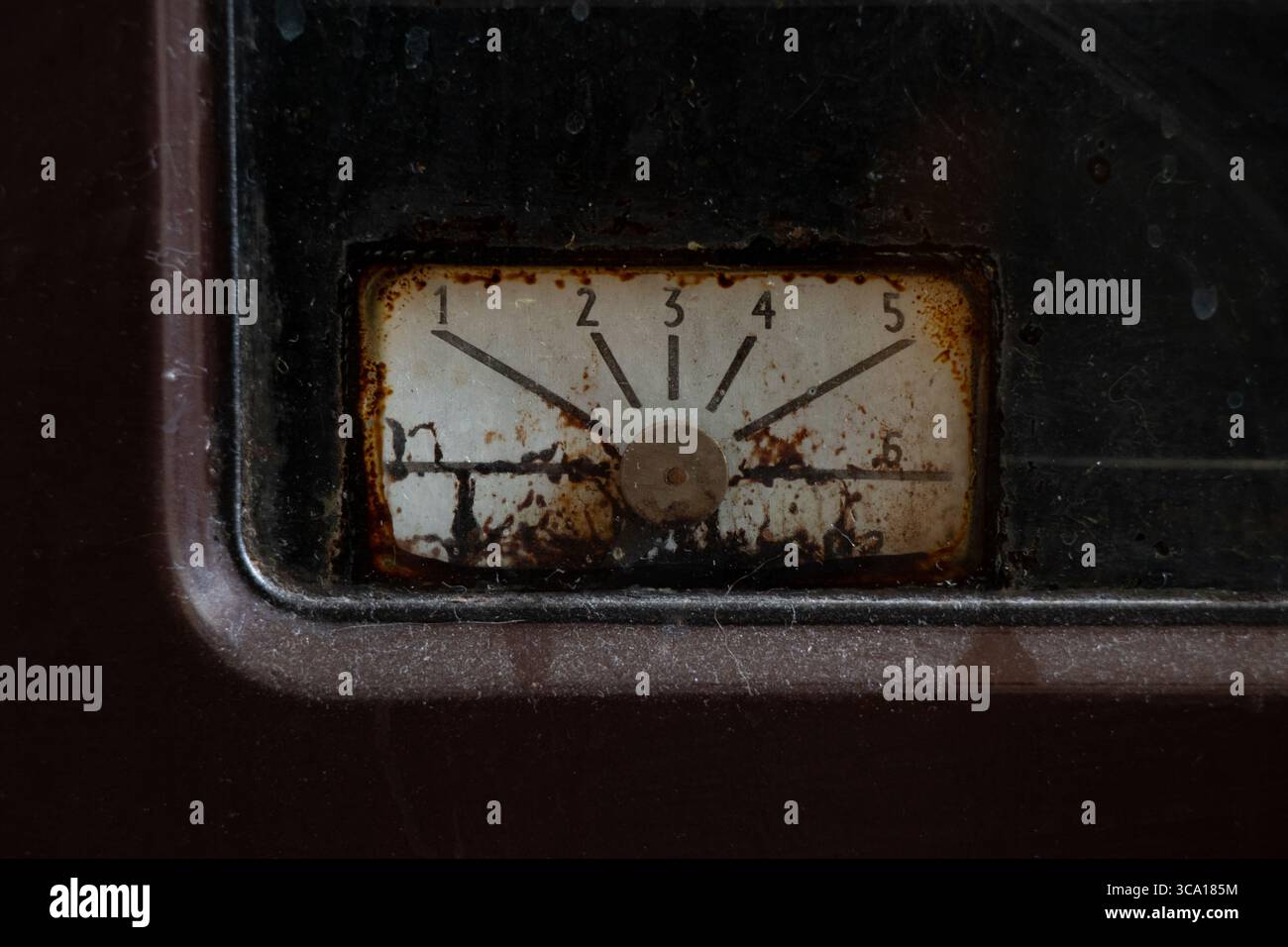 Vecchio comparatore arrugginito sul forno a gas in cucina, primo piano, apparecchio vintage, pannello sporco con numeri Foto Stock